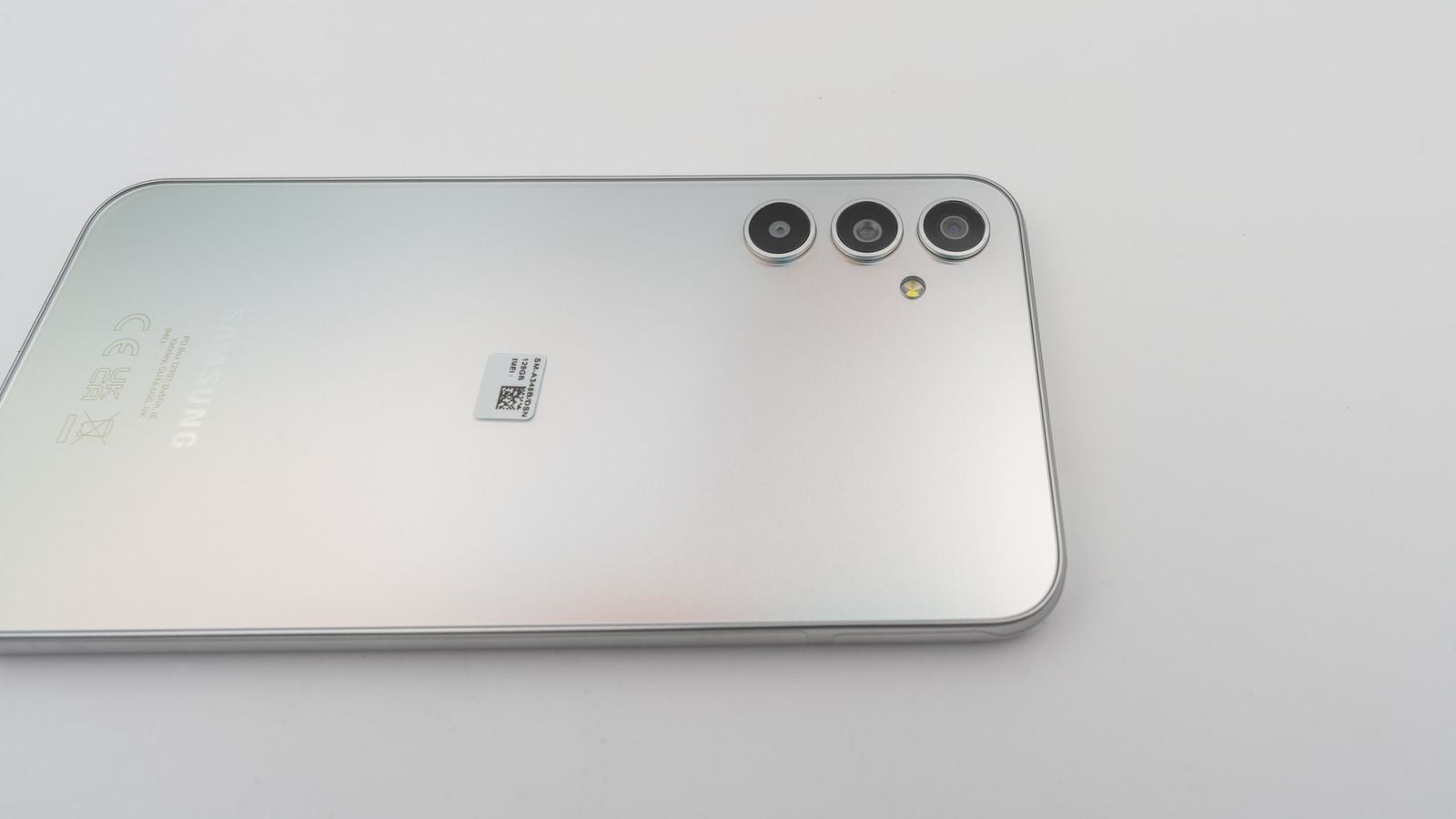 Zadní strana Samsung Galaxy A34, stříbrná barva, detail trojitého fotoaparátu a blesku
